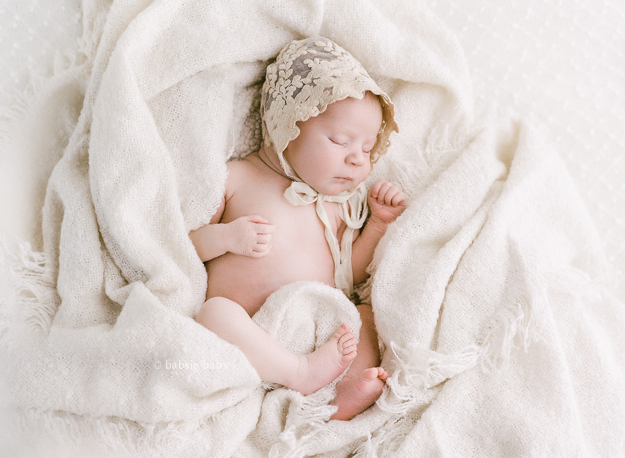 Timeless baby bonnet on a newborn girl at her photo session.